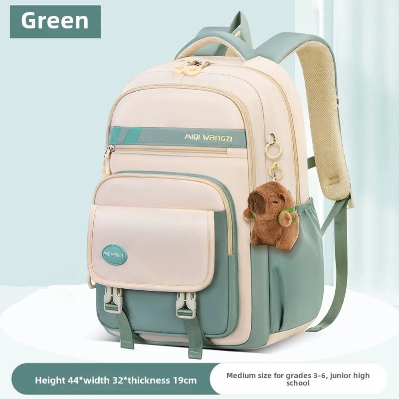 Children's school backpack with cartoon pendant