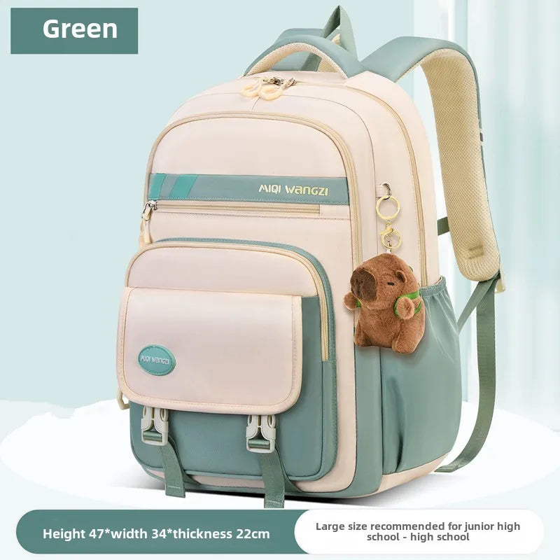 Children's school backpack with cartoon pendant
