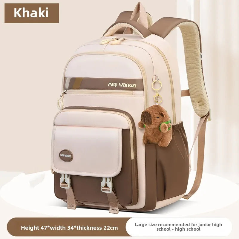 Children's school backpack with cartoon pendant