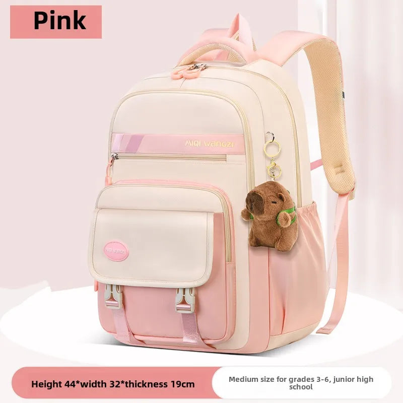 Children's school backpack with cartoon pendant